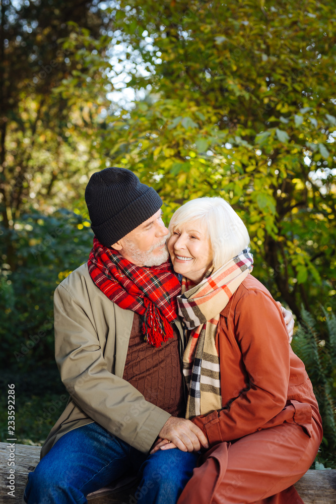 Nice caring man hugging his beloved wife