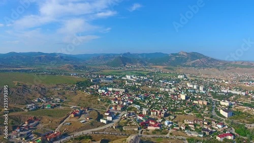 Wallpaper Mural Aerial drone view of green mountains, beautiful cityskype, centre, street, road and car, Crimea. Aerial Drone footage of city-resort Sudak coastline with sea and hotels, buildings and beach. Torontodigital.ca