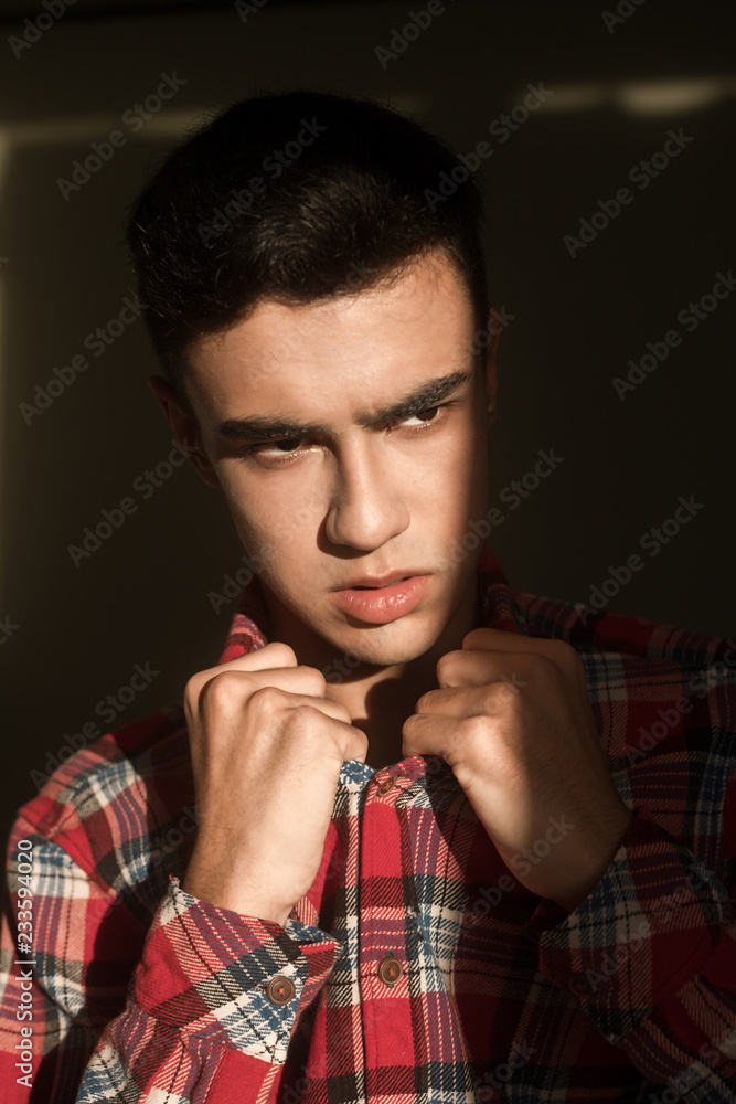 The portrait of young white boy looking aside posing isolated over green wall background The portrait of young white boy looking aside posing isolated over green wall background