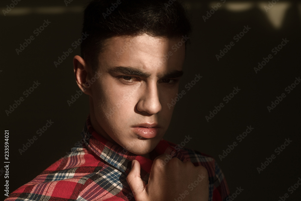 Fototapeta premium The portrait of young white boy looking camera posing isolated over green wall background