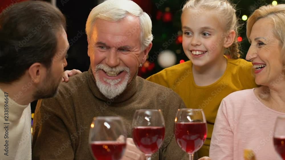 Family chatting and joking at Christmas dinner, happy to meet for holidays Family chatting and joking at Christmas dinner, happy to meet for holidays
