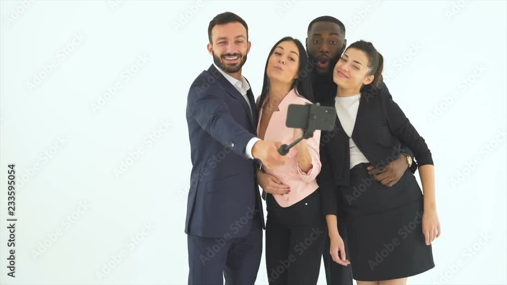 The four business people taking selfie on the white background. slow motion The four business people taking selfie on the white background. slow motion