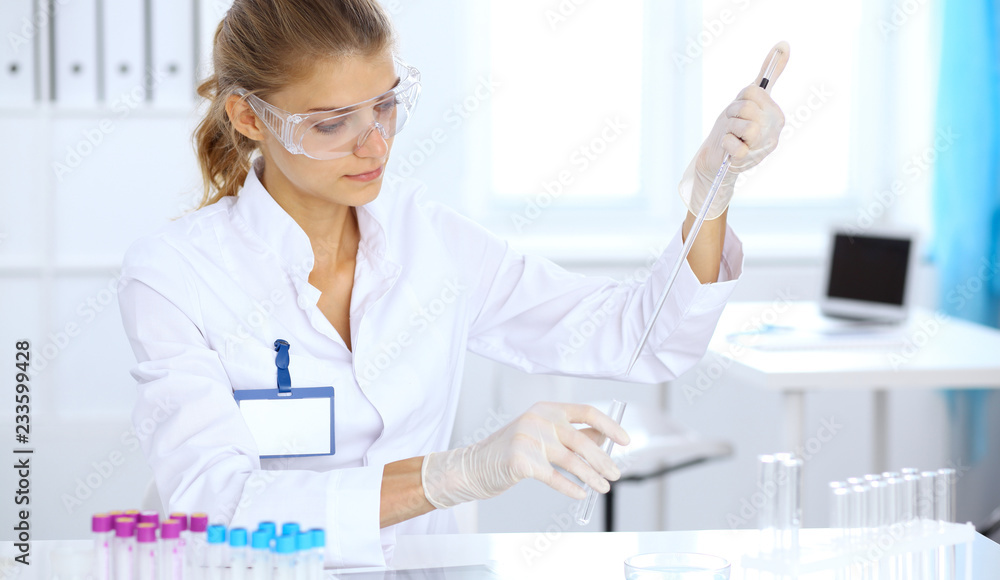 Female scientific researcher or blood test assistant at work in laboratory. Science, medicine and pharmacy concept Female scientific researcher or blood test assistant at work in laboratory. Science, medicine and pharmacy concept