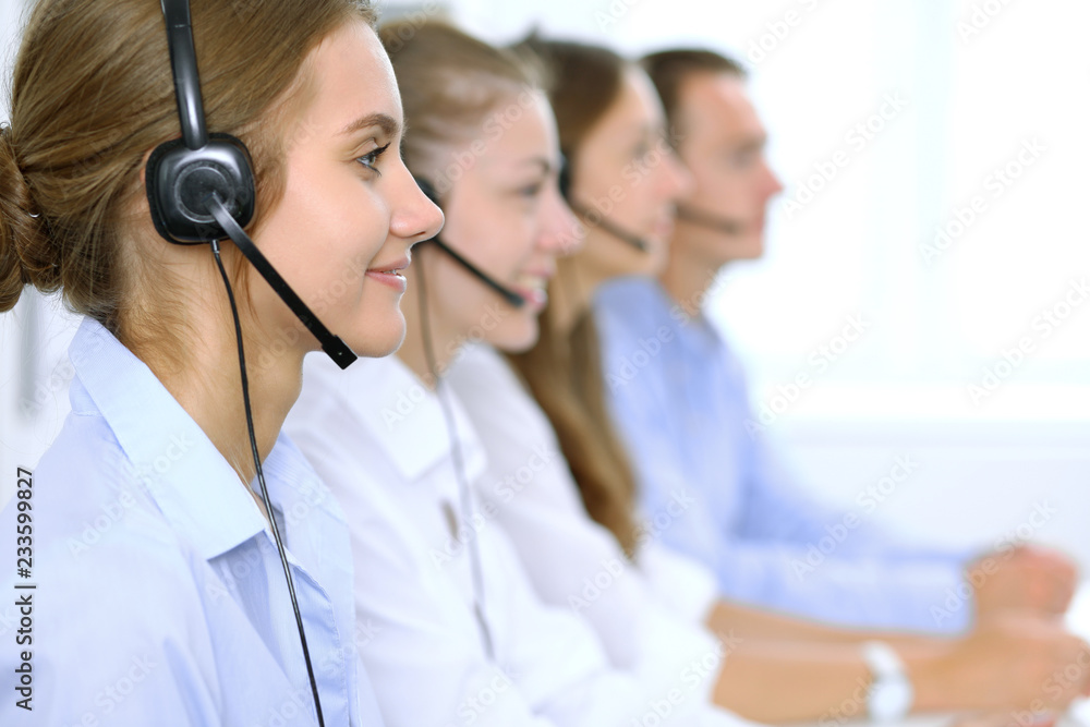 Call center operator in headset while consulting client. Telemarketing or phone sales Call center operator in headset while consulting client. Telemarketing or phone sales