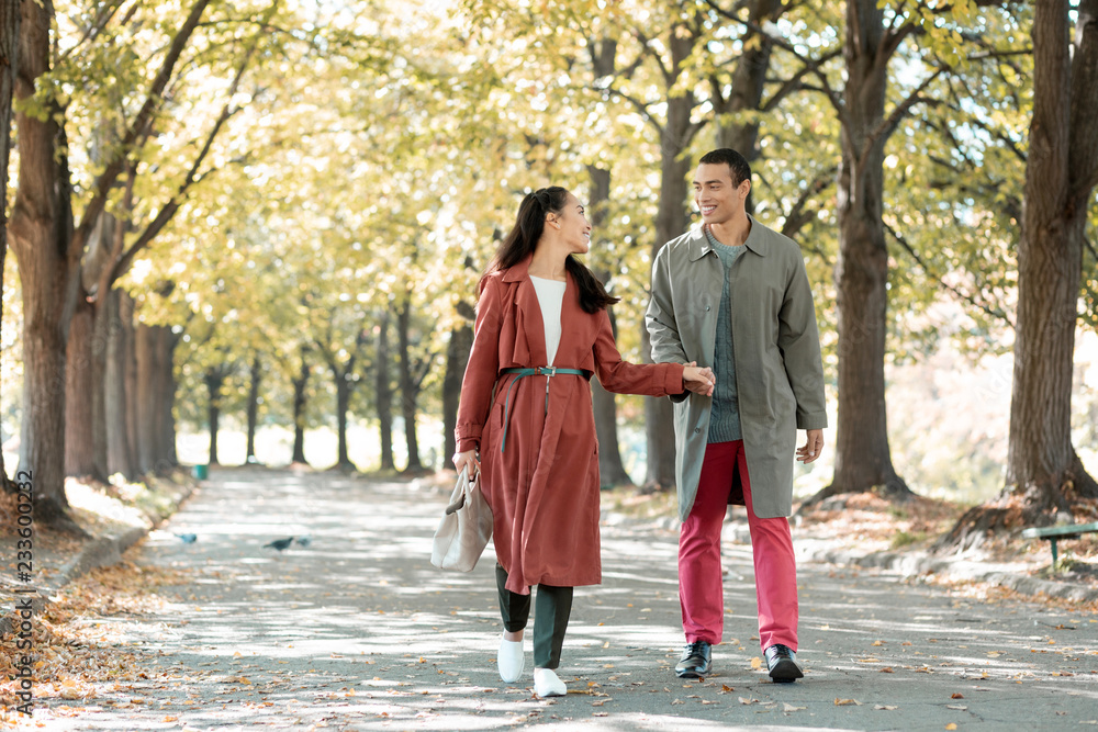 Relaxed loving couple walking after dinner in cafe