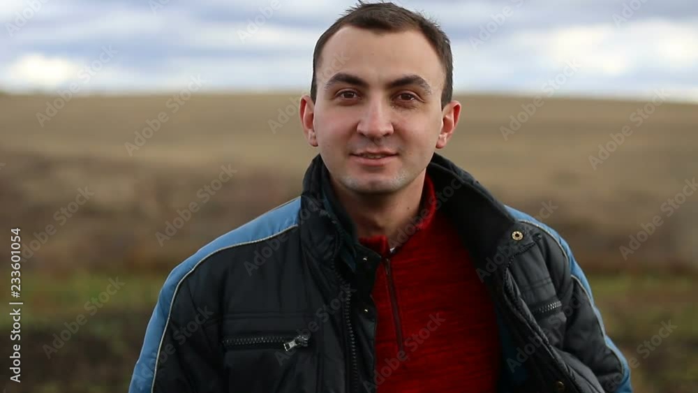 Young handsome man talking about something at camera, outdoor Young handsome man talking about something at camera, outdoor