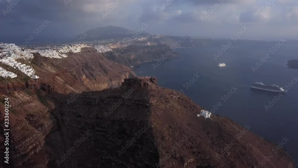 Flight around of Skaros rock and Imerovigli village at sunset, Santorini island, Greece Flight around of Skaros rock and Imerovigli village at sunset, Santorini island, Greece