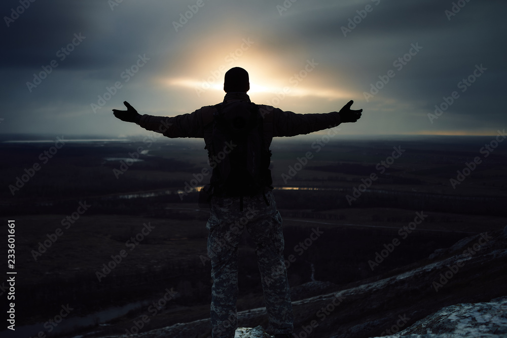 silhouette of a man on sunset background of the sky