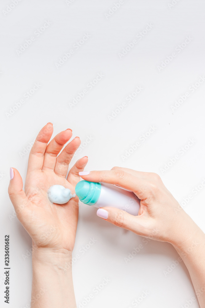 Woman moisturizing her hands with foam lotion Woman moisturizing her hands with foam lotion