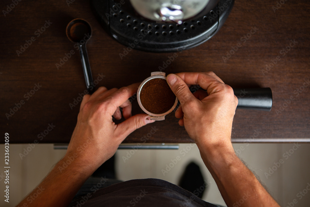 Photo of coffee maker, man hand pouring coffee