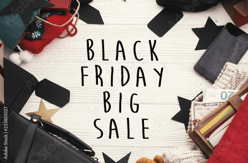 Black Friday big sale text sign. Special discount christmas offer. Advertising message at gift boxes, price tags, credit cards, money, bags, wallet on rustic background. Christmas shopping