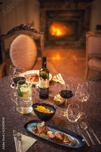 food and wine in restaurant, winter time, romantic dinner with fireplce