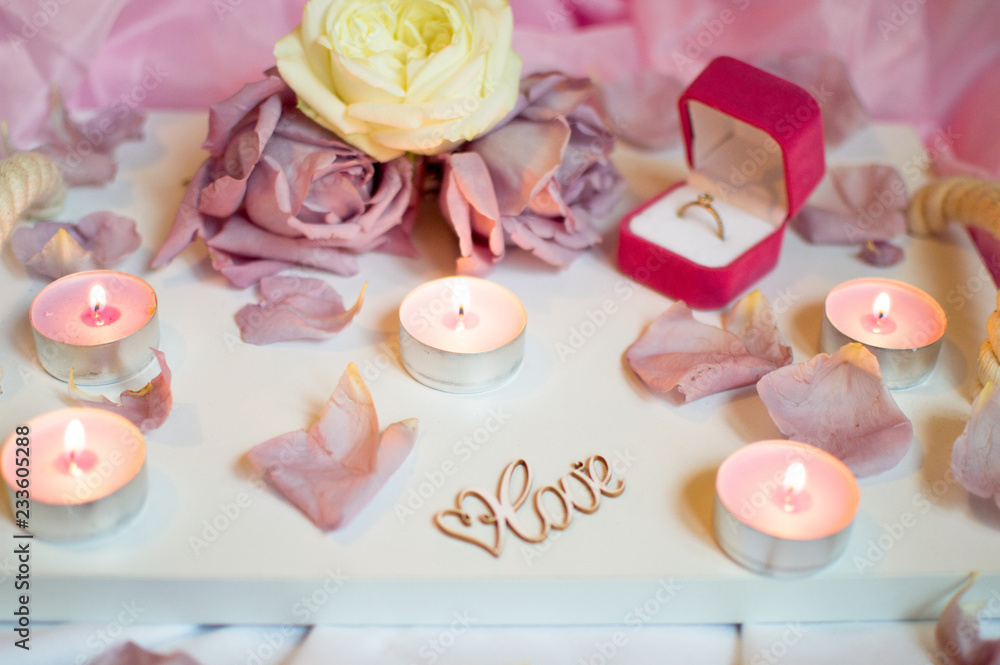 Valentine's Day Surprise. Romantic evening with the beloved with rose petals on the bed and a ring for a marriage proposal on February 14 Valentine's Day Surprise. Romantic evening with the beloved with rose petals on the bed and a ring for a marriage proposal on February 14