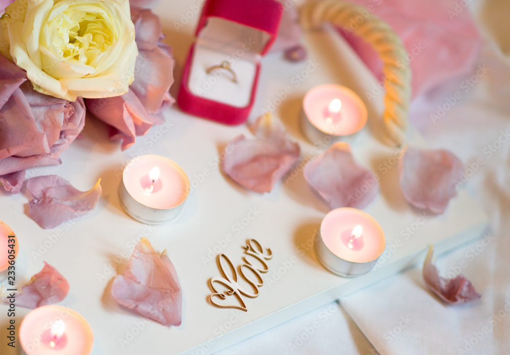 Valentine's Day Surprise. Romantic evening with the beloved with rose petals on the bed and a ring for a marriage proposal on February 14 Valentine's Day Surprise. Romantic evening with the beloved with rose petals on the bed and a ring for a marriage proposal on February 14