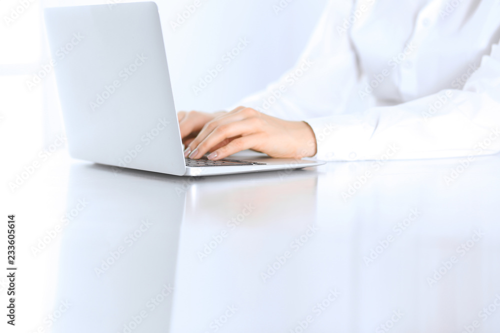 Close-up of business woman hands typing on laptop computer. Secretary at work in office Close-up of business woman hands typing on laptop computer. Secretary at work in office