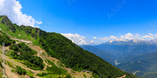 panorama of the mountains and the valley of the river. Mountains near the ski resort of Rosa Khutor in Krasnaya Polyana. Sochi, Russia. photo