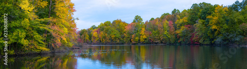 Panorama of fall colors along a pond in New Jersey 