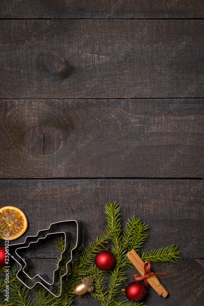 Dark rustic wooden table background with Christmas decoration and fir frame. Top view with free space for copy text Dark rustic wooden table background with Christmas decoration and fir frame. Top view with free space for copy text