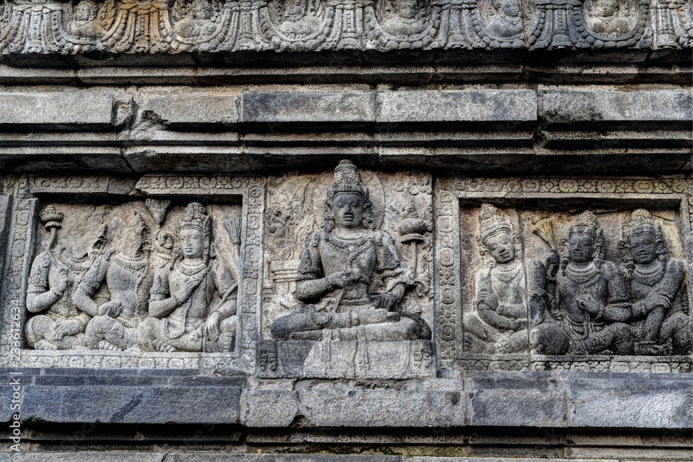 Ancient stone bas-relief of meditating Buddha, Shrine of Prambanan hindu temple, Yogyakarta, Central Java, Indonesia