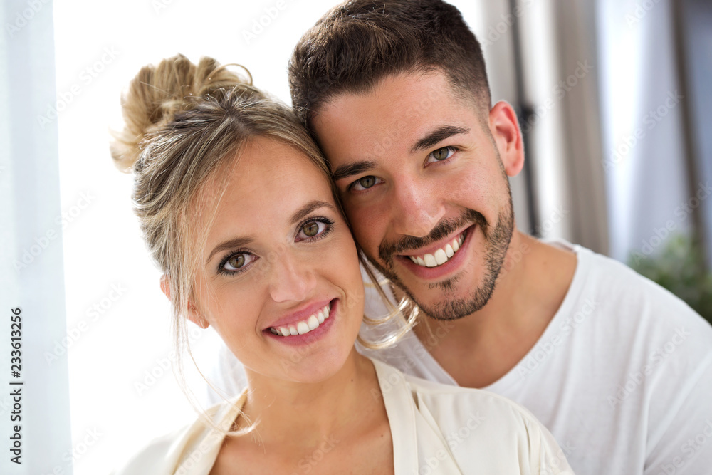 Beautiful young lovely couple looking at camera at home. Beautiful young lovely couple looking at camera at home.