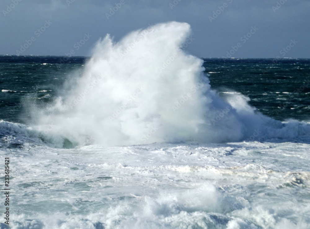 wave crashing against rocks by storm at sea in galicia, spain