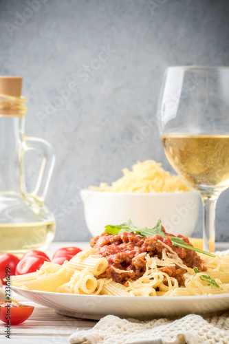 Italian pasta bolognese from pasta penne rigatone minced meat in tomato sauce and parmesan cheese