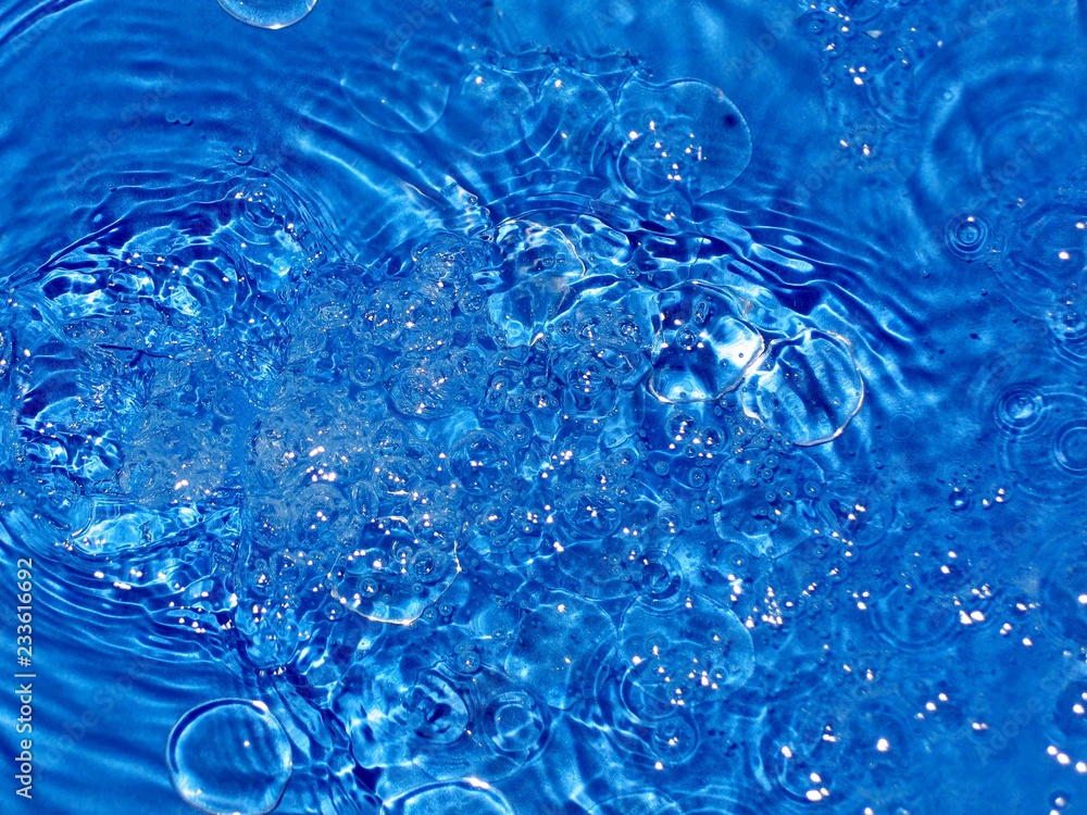 lots of small bubbles in running water, beautiful blue background lots of small bubbles in running water, beautiful blue background