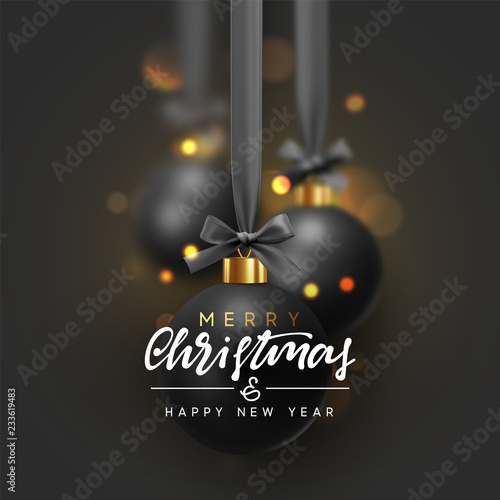 Christmas background with black balls hanging on ribbon with bows and bright sparkling bokeh lights.