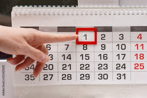 Finger pointing to a calendar