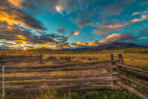 OCTOBER 3, 2018, RIDGWAY COLORADO USA - Sunrise on worm western fence in front of San Juan Mountains in Old West of Southwest Colorado near Ridgway
