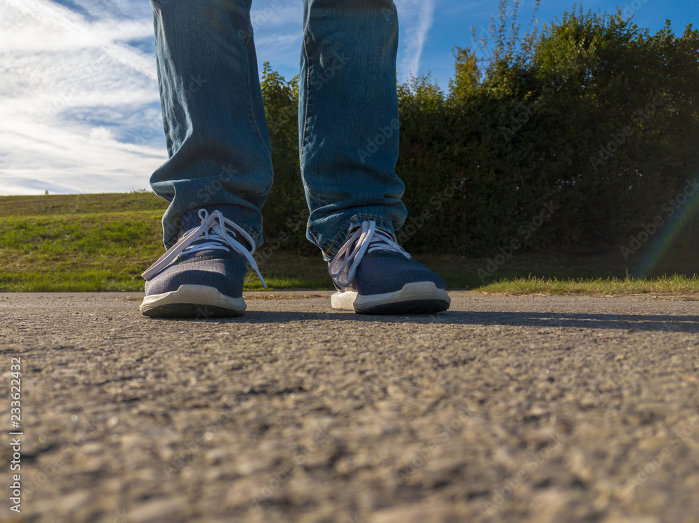 man feet on cobbled road man feet on cobbled road