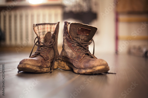 Valokuva Close-up of dirty boots on hardwood floor at home