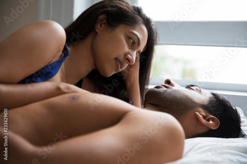 Slika na platnu Affectionate couple relaxing in bed at home