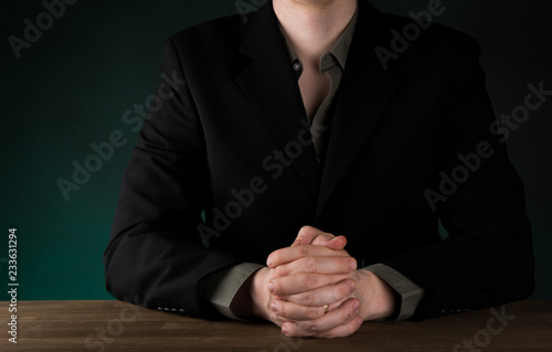 Businessman Clenching hands in front of the body gesture, on gradient green background