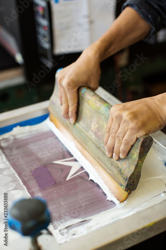 Quadro su tela Cropped image of worker pressing ink on frame in workshop