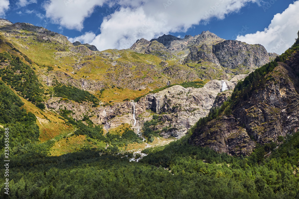 Mountain landscape with small waterfall and river Mountain landscape with small waterfall and river