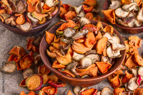 Rural still-life, background - dried fruits from apples and pears in clay bowl close-up, selective focus © rustamank