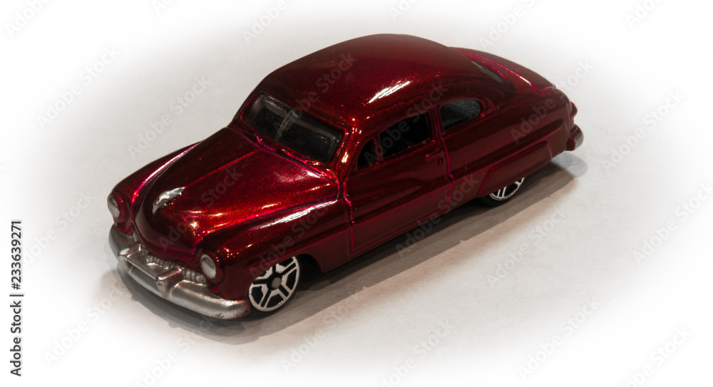 Red car. Scale model of a retro car. Style. White background. Macro mode. Red. Red car. Scale model of a retro car. Style. White background. Macro mode. Red.