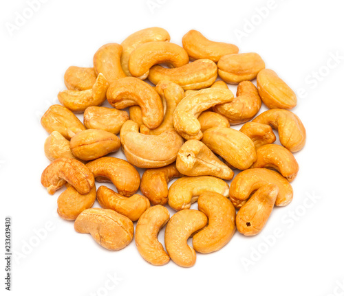 Handful of roasted cashew seeds (Anacardium occidentale) without shell, close up, isolated on white background