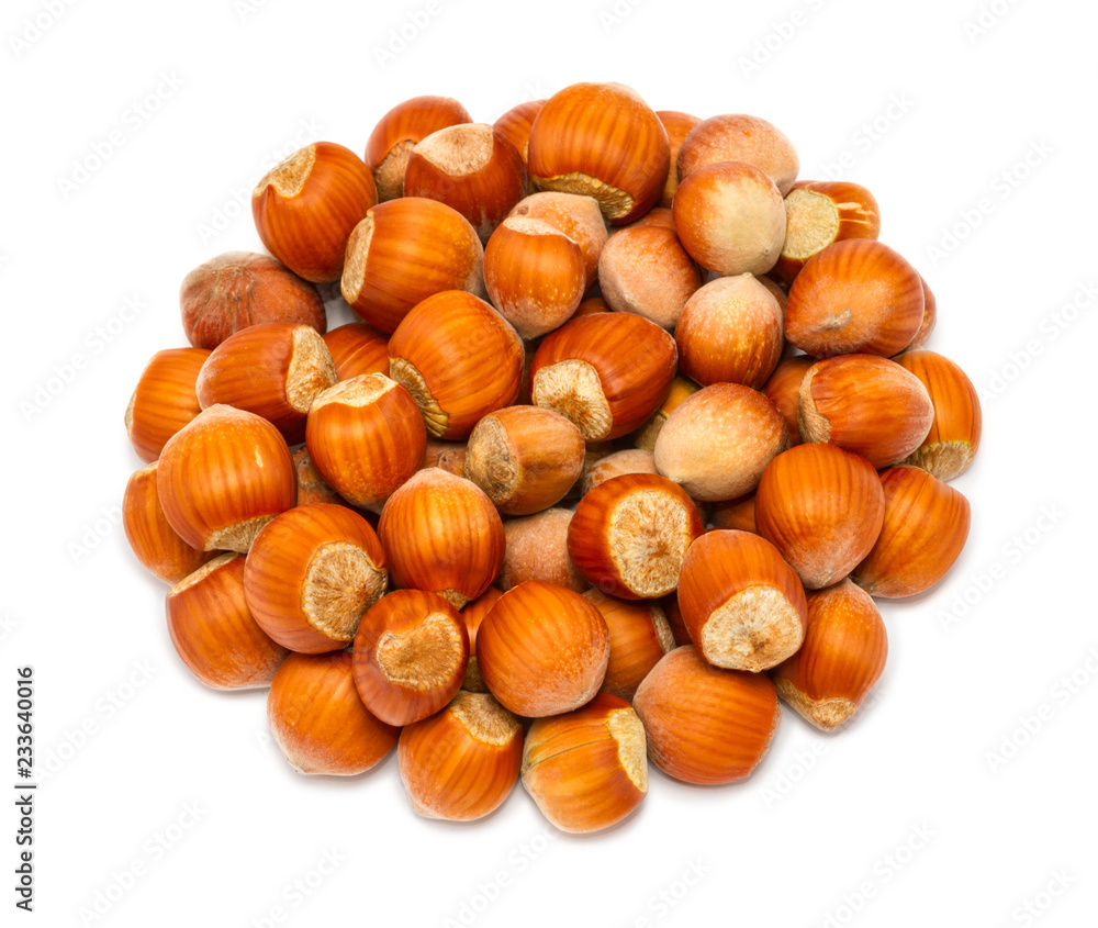 Handful of ripe hazelnuts in the shell close up, isolated on white background Handful of ripe hazelnuts in the shell close up, isolated on white background