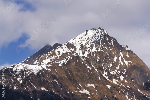 Snow on Hintereggkogel and Ochsenbug Mountain peaks in ski resort Matrei in Osttirol, Austria, sunny day photo