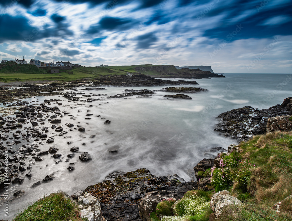 Obraz premium Beautiful sea landscape on Causeway Road, Co Antrim, Northern Ireland.Photo taken on a small road to Dunseverick Harbour. From here you can see Dunseverick Falls.