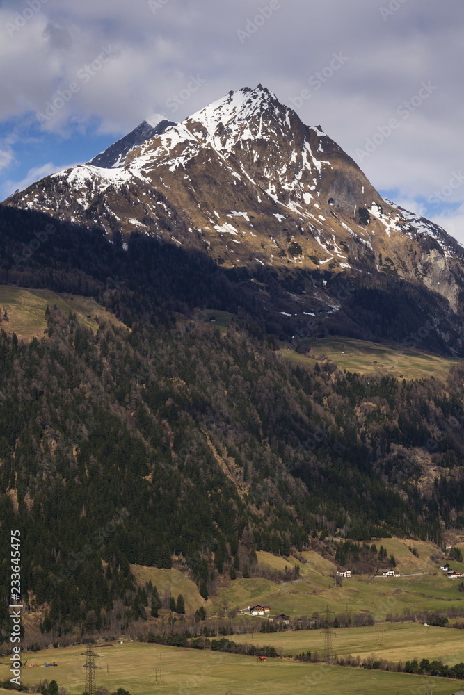 Snow on Hintereggkogel and Ochsenbug Mountain peaks in ski resort Matrei in Osttirol, Austria, sunny day