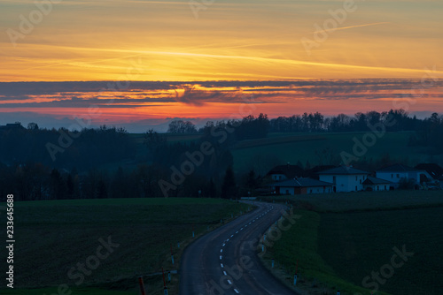 Sonnenuntergang mit Landstraße und Häuser © lexpixelart
