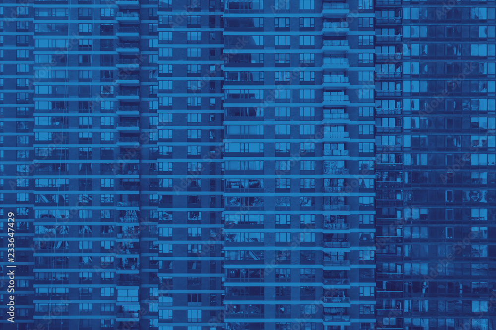 Pattern of windows on a modern apartment building in New York City in blue Pattern of windows on a modern apartment building in New York City in blue