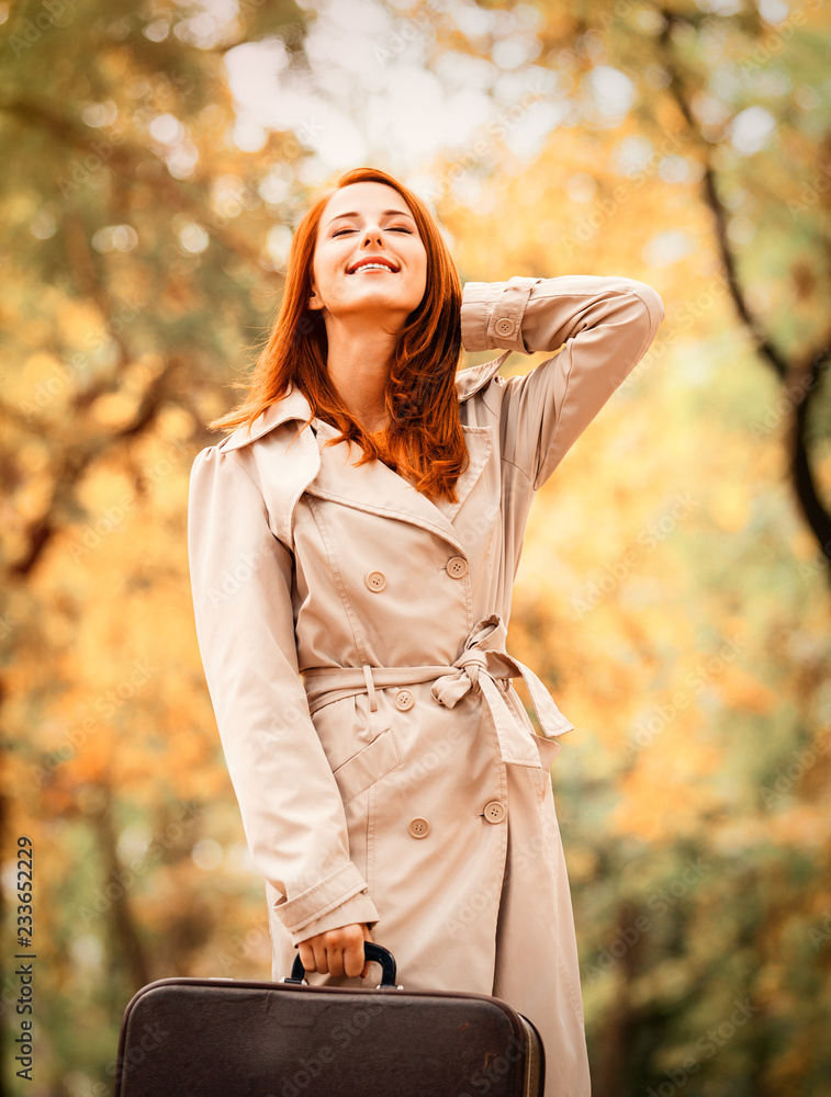 Fashion woman in cloak with suitcase in autumn season outdoor. Fashion woman in cloak with suitcase in autumn season outdoor.