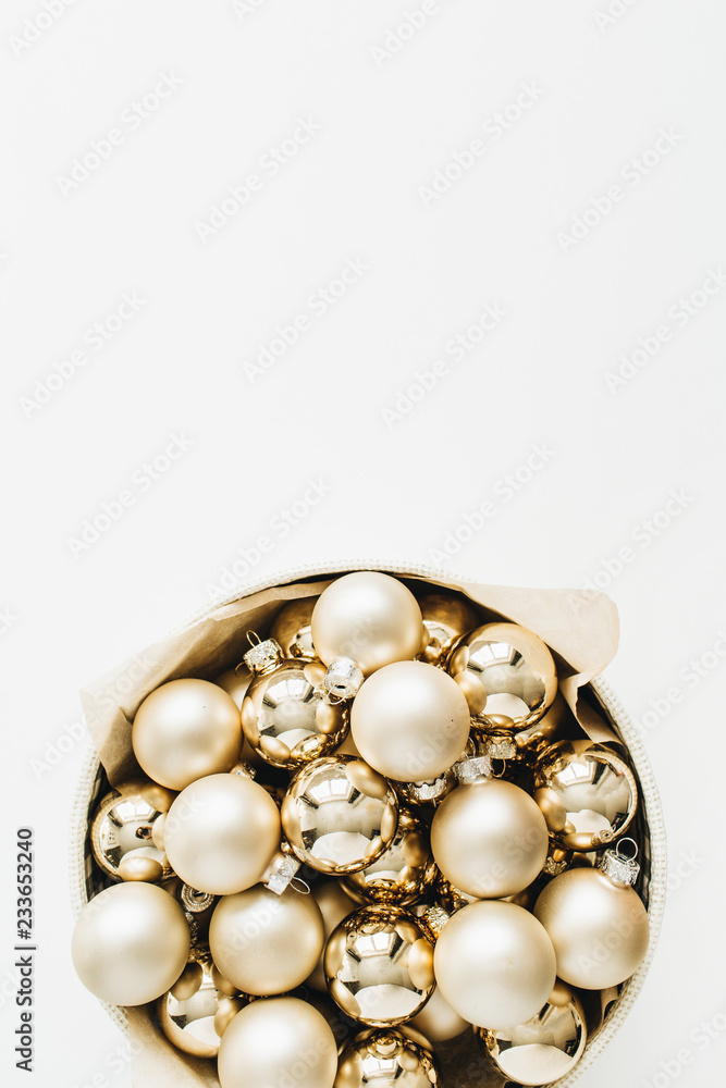 Christmas composition with golden decoration balls on white background. Flat lay, top view. Christmas composition with golden decoration balls on white background. Flat lay, top view.