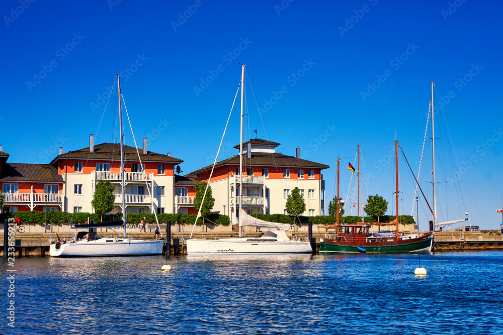 Holiday apartments with sailing boats in the harbor Weiße Wiek.