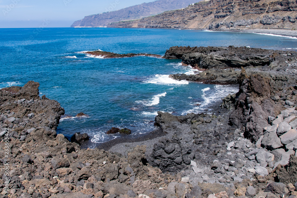 Edge of volcanic lava field meeting the Atlantic Ocean at Playa Los Guirres (Playa Nueva), La Palma, Canary Islands, Spain Edge of volcanic lava field meeting the Atlantic Ocean at Playa Los Guirres (Playa Nueva), La Palma, Canary Islands, Spain