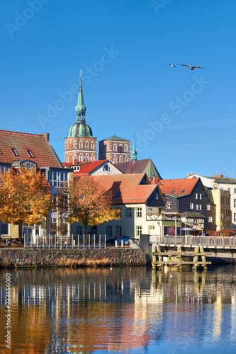 Historical houses and brick towers of Stralsund in Northern Germany with reflection photo